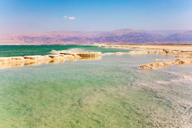 Unique Dead Sea. The drainless salt lake in the Middle East, the saltiest lake in the world. On the surface of the water, the evaporated salt forms bizarre crystal shapes. Warm winter February day