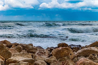 Stormy Mediterranean Sea off the coast of the old port of Tel Aviv. Huge waves crash against the rocks. Magnificent storm. 
