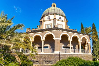 Magnificent monastery surrounded by columns and slender tall palms. Easter is the feast of the resurrection of Christ. The Church of the Beatitudes is a Catholic church of the Italian Franciscan convent. 