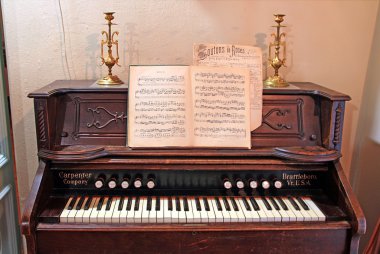Old-time harpsichord in dark room clipart