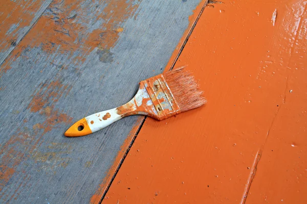 Dirty brush in red paint — Stock Photo, Image