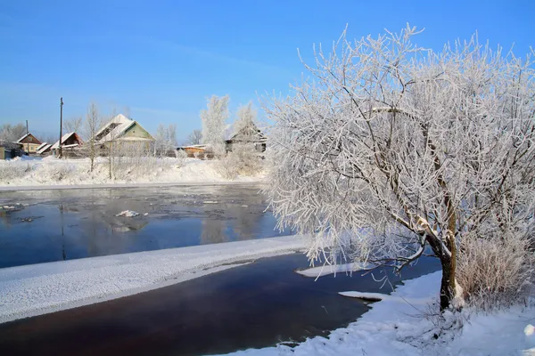 Winter ice on river near villages — Stock Photo, Image