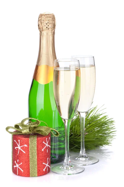 Champagne bottle, glasses and christmas decor — Stock Photo, Image