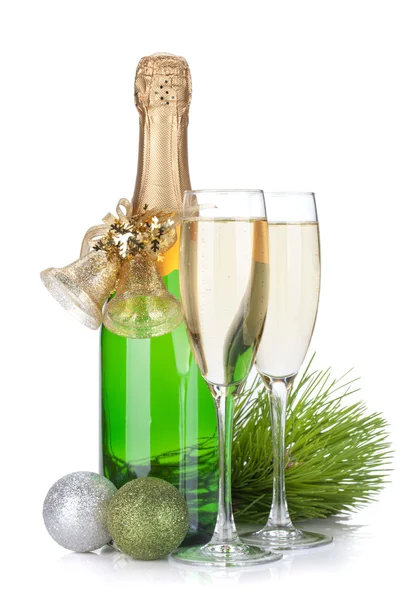 Champagne bottle, glasses and christmas decor — Stock Photo, Image