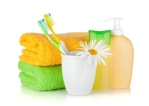 Toothbrushes, shampoo bottles, two towels and flower — Stock Photo, Image