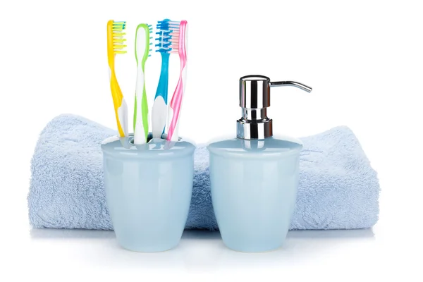 Toothbrushes, liquid soap and towel — Stock Photo, Image