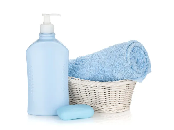 Shampoo bottle, soap and blue towel — Stock Photo, Image