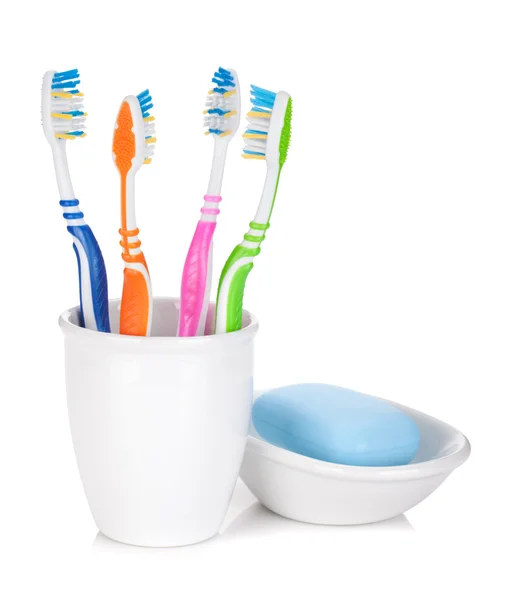 Four colorful toothbrushes and soap — Stock Photo, Image