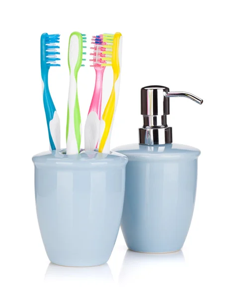 Four colorful toothbrushes and liquid soap — Stock Photo, Image