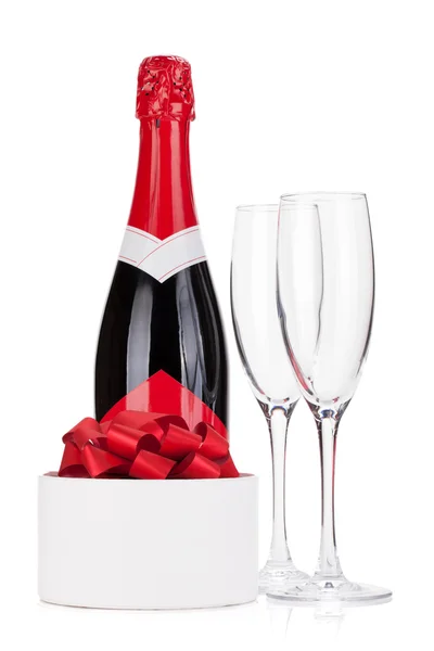 Champagne bottle, glasses and gift — Stock Photo, Image