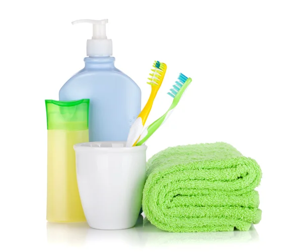 Toothbrushes, cosmetics bottles and towel — Stock Photo, Image