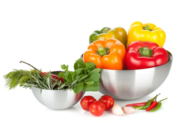 Fresh bell peppers and herbs in bowls — Stock Photo, Image