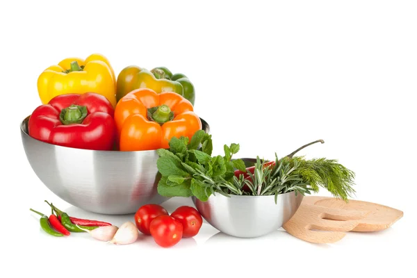 Fresh bell peppers and herbs in bowls — Stock Photo, Image