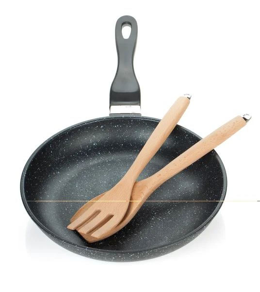 Frying pan with wooden utensils — Stock Photo, Image