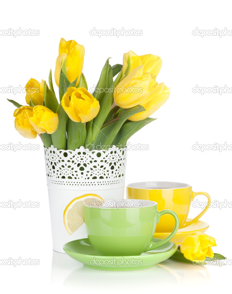 Yellow tulips and tea with lemon