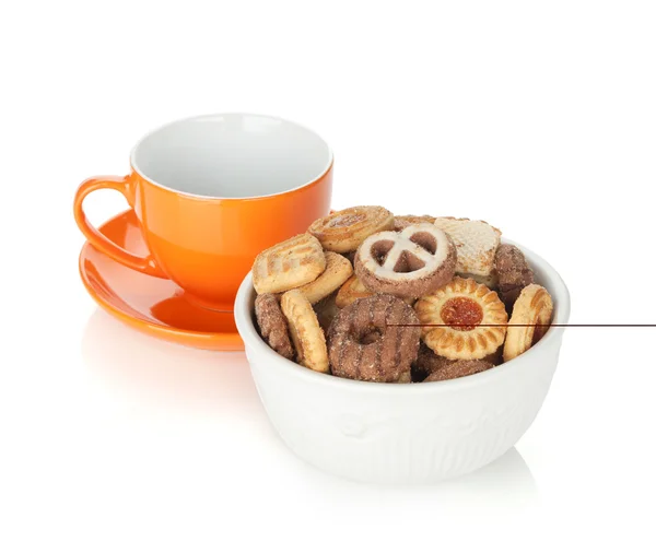 Various cookies in bowl and orange tea cup — Stock Photo, Image