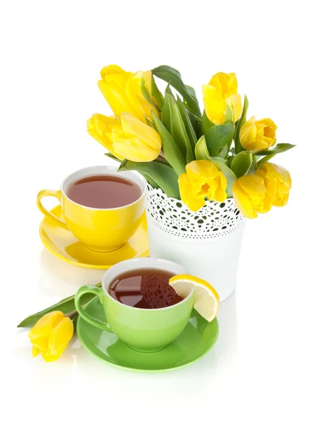 Yellow tulips and tea with lemon — Stock Photo, Image