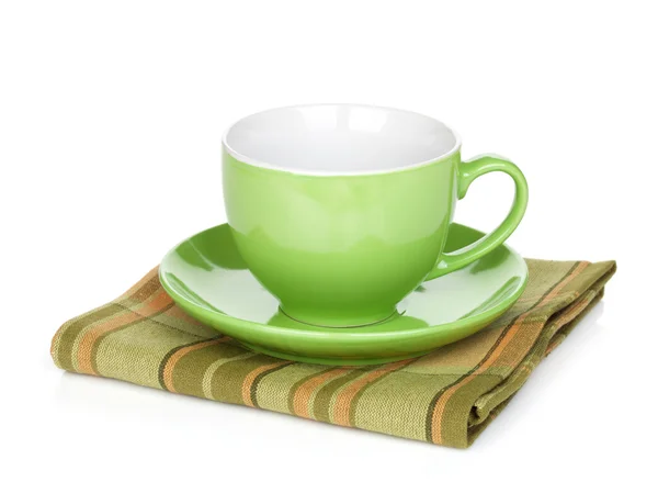 Coffee cup over kitchen towel — Stock Photo, Image