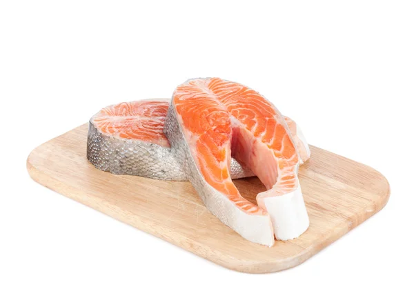 Salmon steaks on cutting board — Stock Photo, Image