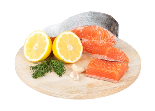 Salmon on cutting board with lemons and herbs — Stock Image Salmon on cutting board with lemons and herbs Stock Image
