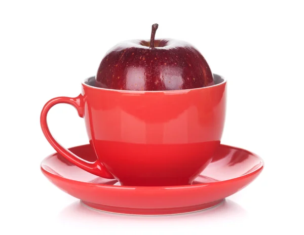 Ripe red apple in tea cup — Stock Photo, Image