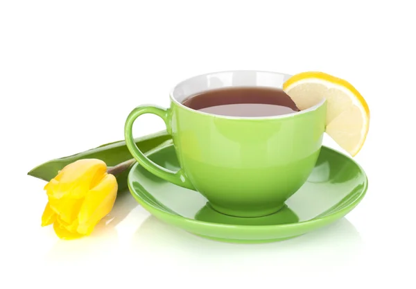 Green tea cup and yellow tulip — Stock Photo, Image