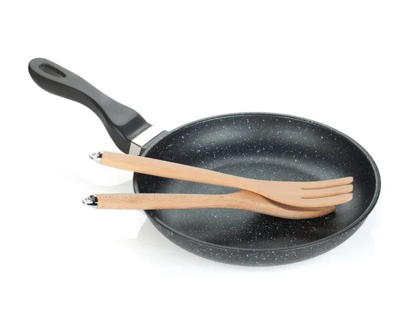 Frying pan with wooden utensils — Stock Photo, Image