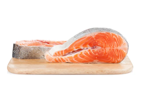 Salmon steaks on cutting board — Stock Photo, Image