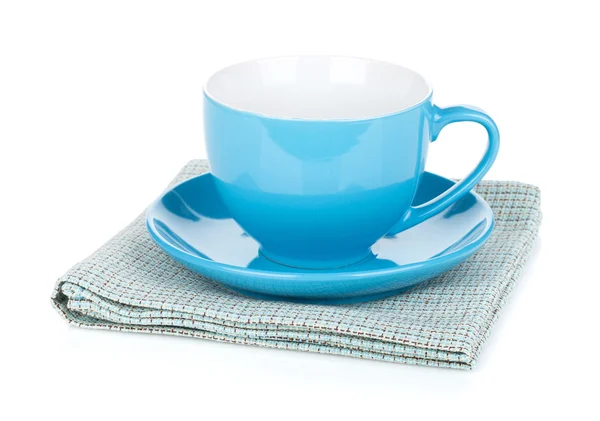 Coffee cup over kitchen towel — Stock Photo, Image
