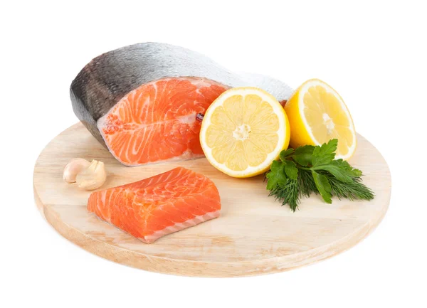 Salmon on cutting board with lemons and herbs — Stock Photo, Image