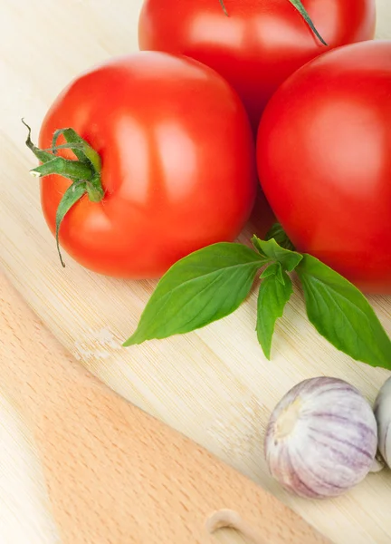 Three ripe tomatoes and basil — Stock Image Three ripe tomatoes and basil Stock Image