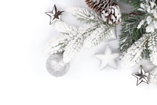 Ramo di abete con decorazioni natalizie ricoperto di neve — Foto Stock