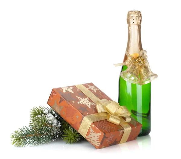 Champagne bottle, christmas gift box, decor and fir tree — Stock Photo, Image