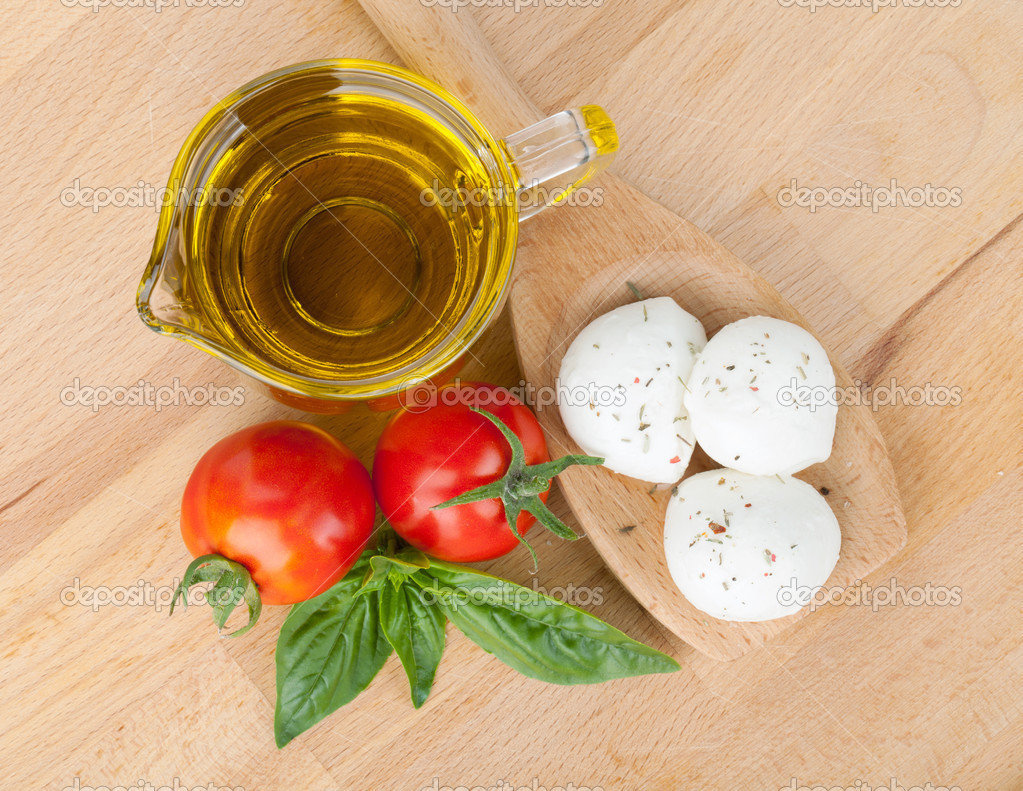 Mozzarella, olive oil, tomatoes and basil Stock Photo by ©karandaev