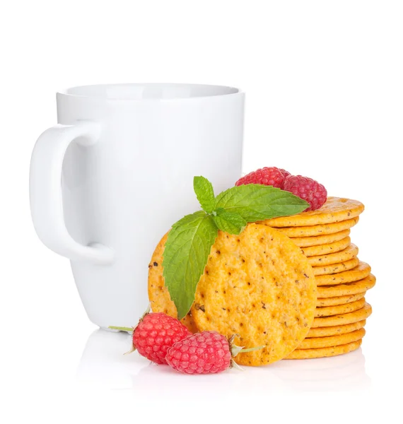 Stack of crackers with mint, berries and cup of drink — Stock Photo, Image
