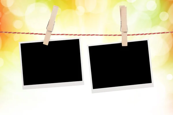 Blank photos hanging on clothesline — Stock Photo, Image