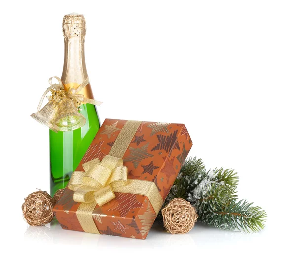 Champagne bottle, christmas gift box, decor and fir tree — Stock Photo, Image