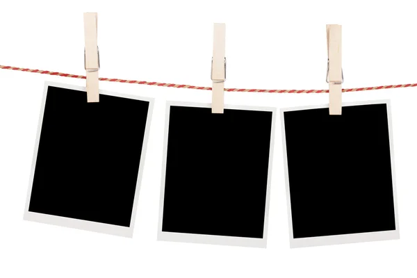 Blank photos hanging on clothesline — Stock Photo, Image