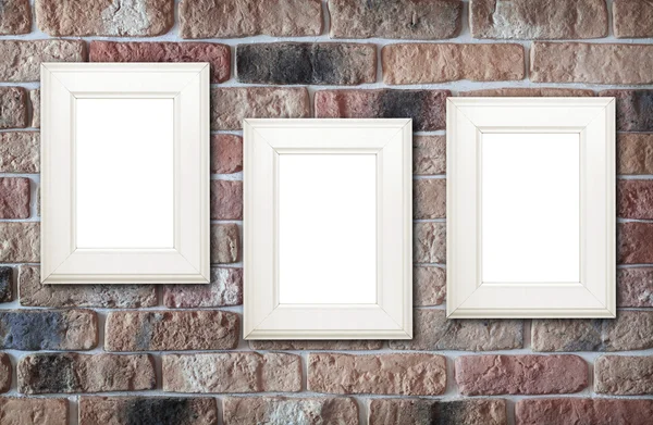 Photo frames on brick wall — Stock Photo, Image