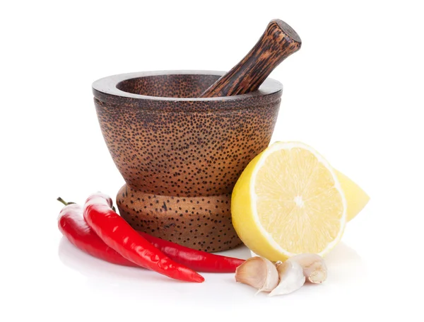 Mortar and pestle with red hot chili pepper and lemon — Stock Photo, Image