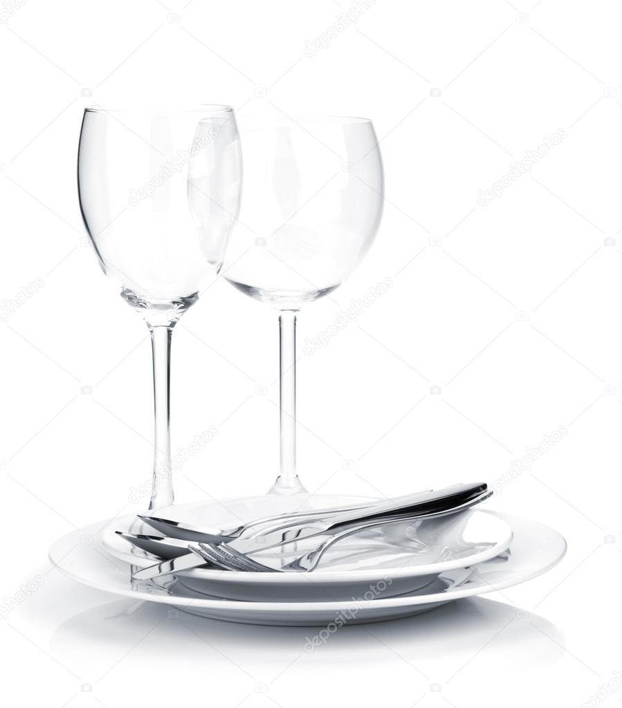 Silverware or flatware on plates and wine glasses