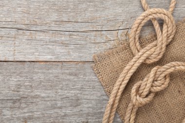 Ship rope on wooden texture background clipart