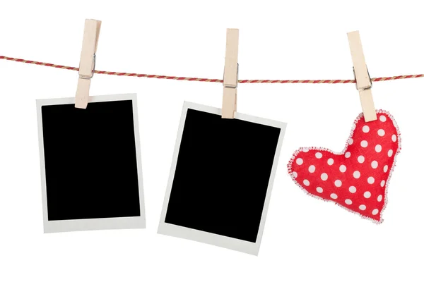 Blank instant photos and red heart hanging — Stock Photo, Image