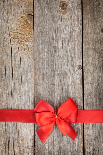 Wooden background with red bow and ribbon — Stock Photo, Image