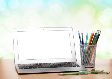 laptop ile boş bir ekran ve renkli kalemler