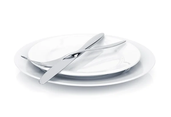 Flatware set of fork and knife over plates — Stock Photo, Image