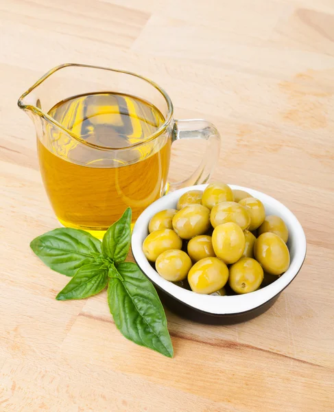 Olives, olive oil and basil — Stock Photo, Image