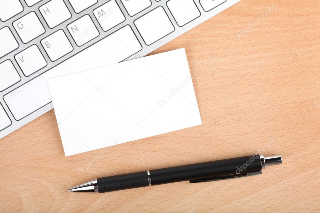 Blank business cards over keyboard on office table