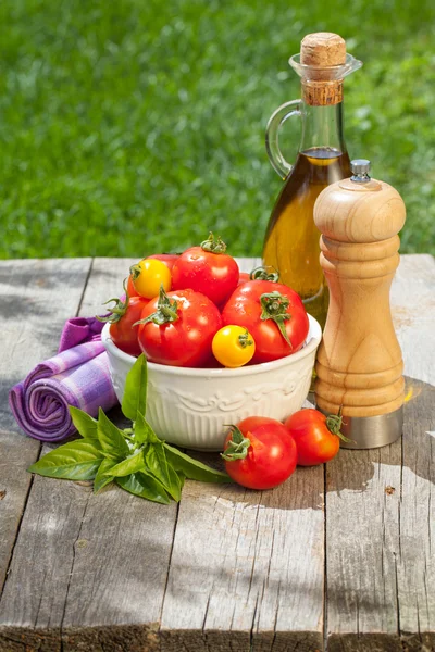 Tomaten, olijfolie, peper schudbeker en kruiden — Stockfoto