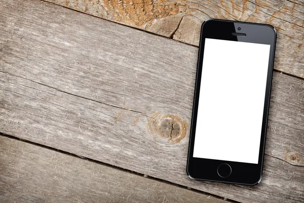 Smart phone on wooden table — Stock Photo, Image